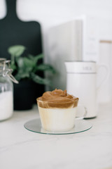 Dalgona coffee. Whipped instant coffee over cold milk.