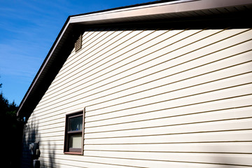 House with pale yellow vinyl siding