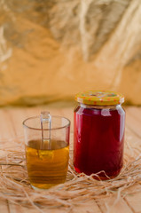 Honey in a jar and tea on a wooden table