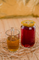 Honey in a jar and tea on a wooden table