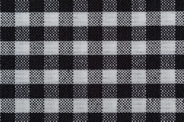 Checkered fabric background. Black cell. Top view, flat lay
