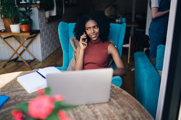 African American female calling friend at workplace