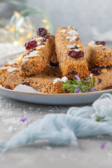 Granola bar. Healthy snack. Cereal granola bar with nuts, fruit, coconut and cranberries on a christmas table