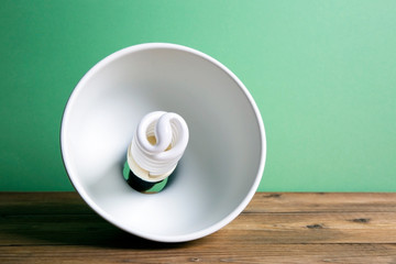 Energy-saving lamp, white chandelier on a colored background
