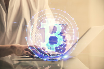 Double exposure of blockchain business sketch hologram and woman holding and using a mobile device.