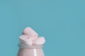 glass jar with milk drink and marshmallows