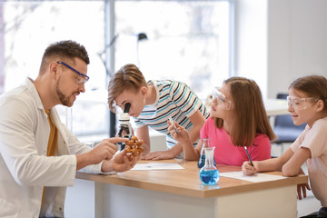 Teacher conducting chemistry lesson in classroom