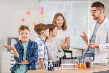 Teacher conducting chemistry lesson in classroom