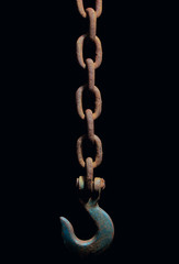 Old and rusty heavy chain and hook on black