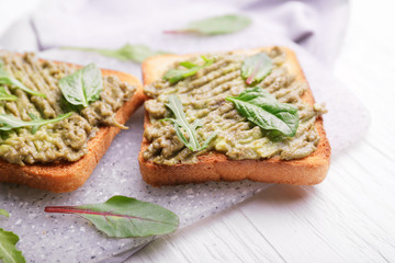 Tasty avocado sandwiches on table