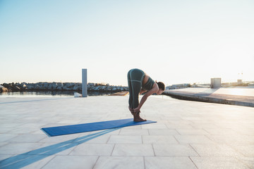 Woman practicing yoga during dawn