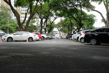 Aerial parking lot outdoors vehicles green park.