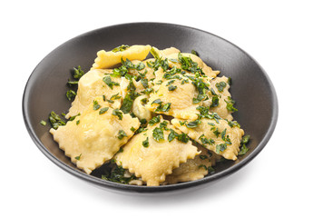 Plate with tasty ravioli on white background