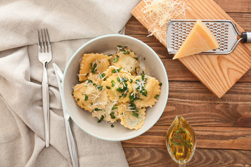 Plate with tasty ravioli on table