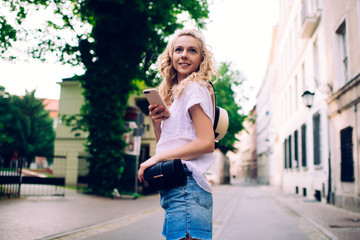 Joyful female walking in town in summertime