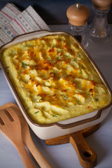 Creamy fish pie or fisherman's pie - traditional British and Irish dish. Overhead horizontal image