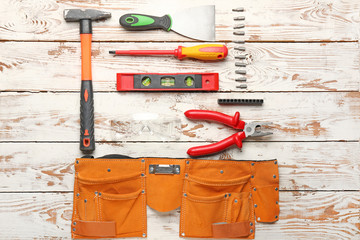 Builder's tools on wooden background