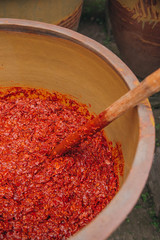 Bright red Sichuan pepper paste being stirred