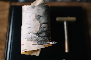Birch bark used as a decoration for a cocktail in a bar. Close up view. Smooth image with shallow depth of field.