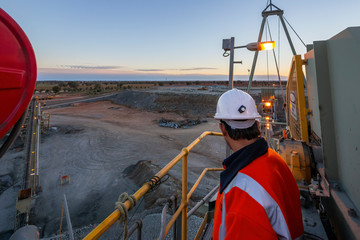 Nyngan Australia June 20th 2012 : Miner on top of a rock crushing platform surveys the minehead in...