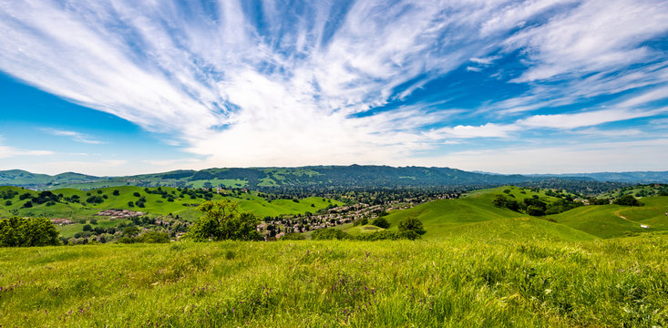 Panoramic view overlooking Camino Tassajara with hiking and walking trail on the slope of a hill in Sycamore Valley Preserve Contra Costa County Danville, California.