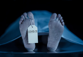 Strong image of feet with toe tag of a dead body coronavirus victim. COVID-19 deaths Health alert