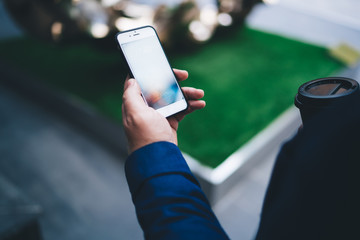 Faceless man using smartphone for work