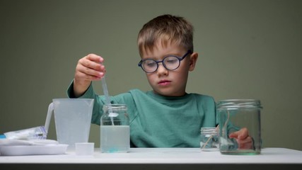 Healthy at home concept. Quarantine, stay at home order. Children and quarantine. Home schooling background. Home laboratory. Little scientist. Doing the experiment. Derive the formula