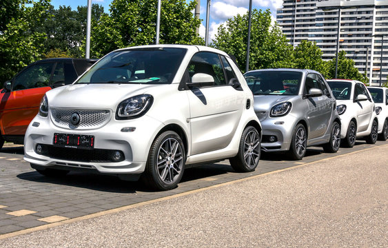 Nurnberg, Germany: A Smart Fortwo car exhibited in front of the Mercedes Benz dealership building with lined up Smart automobiles