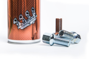 Three bolts with an aerosol can of high-temperature copper grease. The concept of the treatment of...