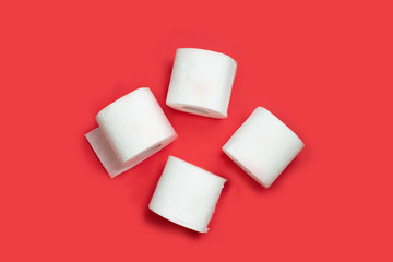 Toilet paper roll on red background. Copy space.