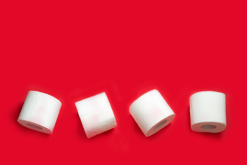 Toilet paper roll on red background. Copy space.