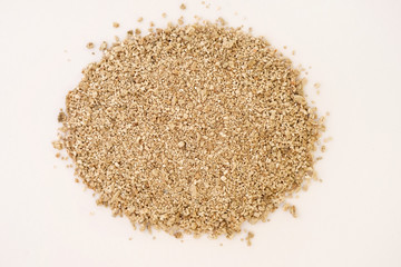 Vermiculite fraction 0.5 cm top view. Vermiculite mineral from the earth's crust on a white...