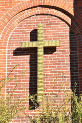 Gold Cross on Brick Building