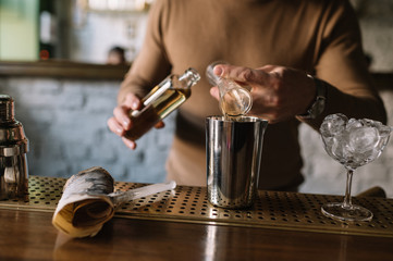 Bartender preparing cocktail based on gin, birch juice and essential oil of frankincense.