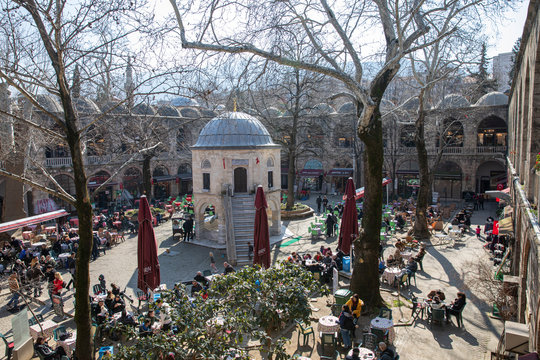Bursa / Turkey - 02/23/2020: Tea gardens, silk shops and little historical mosque in Koza Han Silk Bazaar. Koza Han is historical and very famous place from Ottoman Empire.The entrance door khan.
