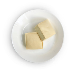 Top view of two blocks of white tofu with plate isolated on white.