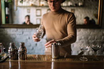 Bartender preparing cocktail based on gin, birch juice and essential oil of frankincense.