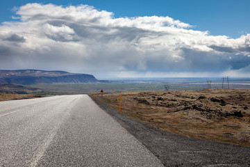 Photo from the road looking out towards the far distance on a sunny summer day in Iceland