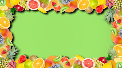 Creative photo of many different exotic tropical bright fruits frame with shadows on a summer green color background. View from above. Bright summer fruit pattern with copy space.