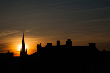 Obraz premium silhouette of the church and buildings at dusk