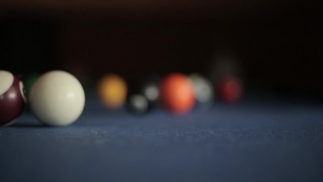 American billiard, 9-ball, nine-ball pool. Man playing billiard with colorful balls