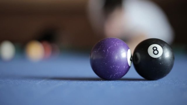 American billiard, 9-ball, nine-ball pool. Man playing billiard with colorful balls