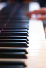 fingers on piano keyboard