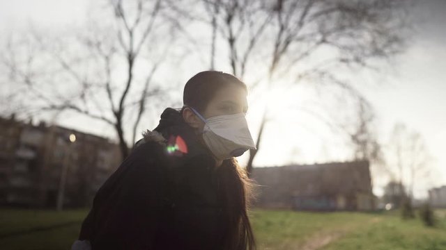 Depressed scared person wearing a N95 mask to prevent contracting disease in spring nature.Coronavirus pandemic life.Infection panic and fear.Emotional effect of the COVID-19.Quarantine mental stress&nbsp;