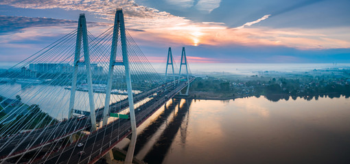 Fototapeta premium Saint Petersburg. Russia. Obukhov bridge. Large cable-stayed bridge in St. Petersburg. Sunset. Cable-stayed bridge across the Neva. View of St. Petersburg from a quadcopter. City landscape.