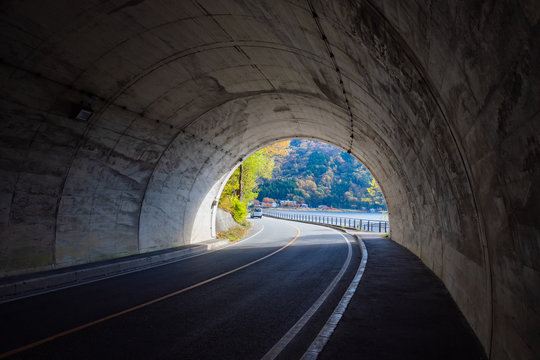 Fototapeta Japan. The tunnel leads to Lake Kawaguchiko. Departure from a tunnel on a highway in Japan. The end of the car tunnel in Fyuzhikavaguchiko. Road architecture of Japan. Trip to Kawaguchiko Lake