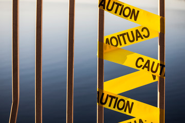 yellow caution tape for the broken bridge fence