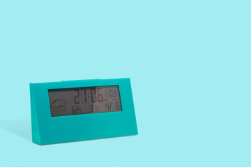 Blue alarm modern clock on blue background.