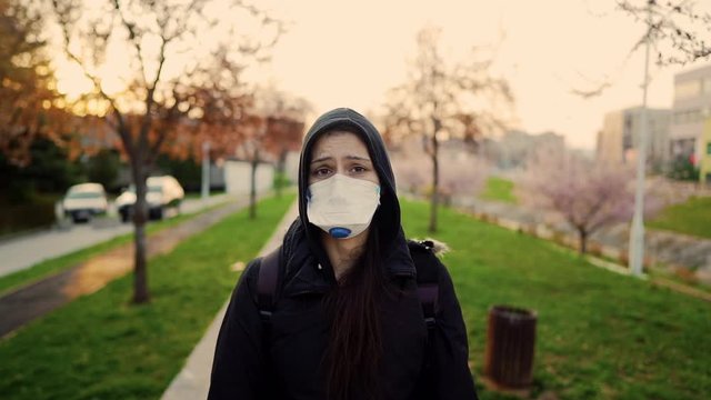 Patient suffering from infectious disease,sick person in N95 mask.Scared woman suffering from symptoms of coronavirus covid-19.Patient in quarantine.Infection panic,fear,anxiety.Viral outbreak